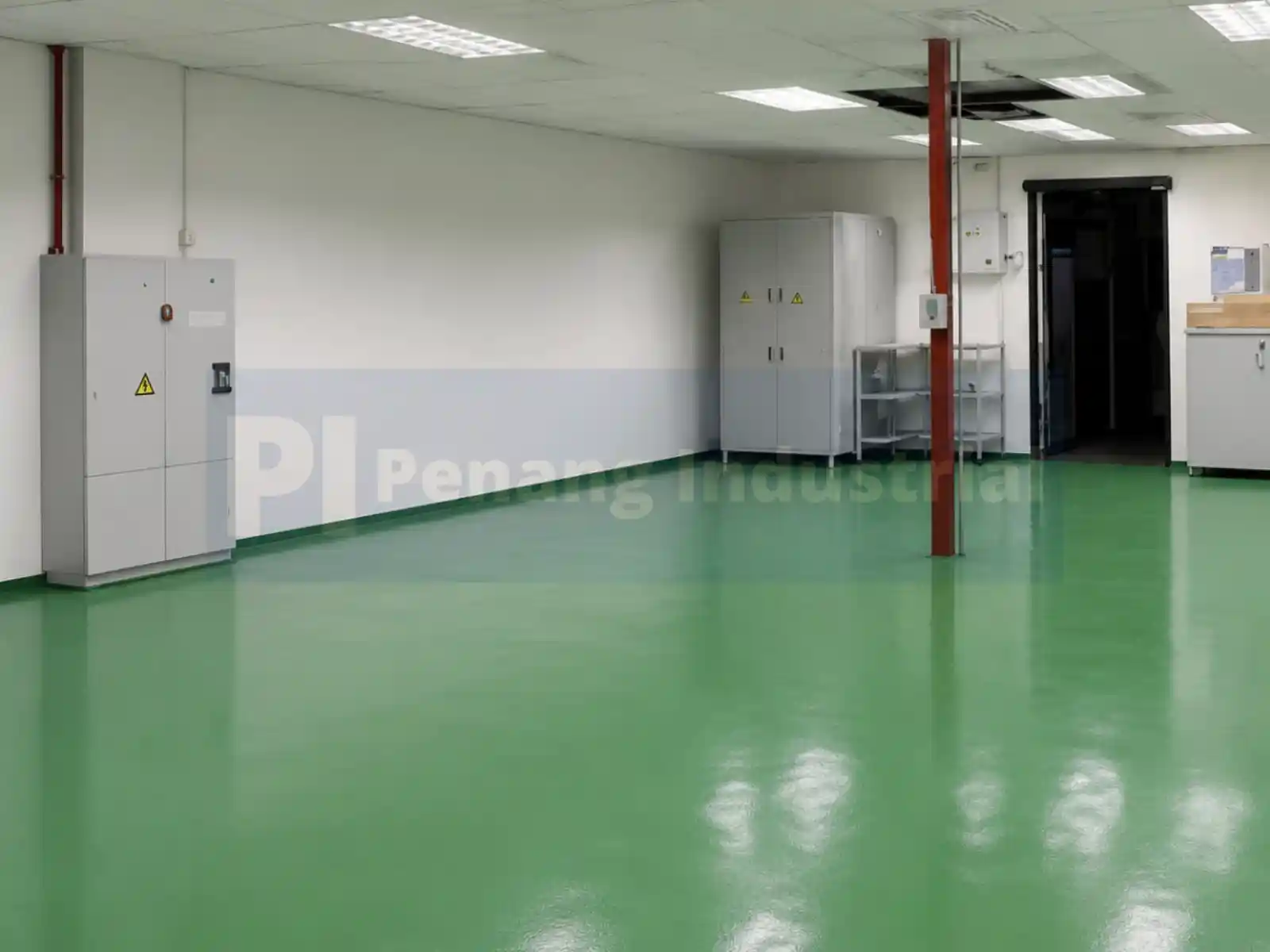 "Interior production area of a factory for sale in Bayan Lepas featuring green epoxy flooring and high-voltage electrical distribution panels."